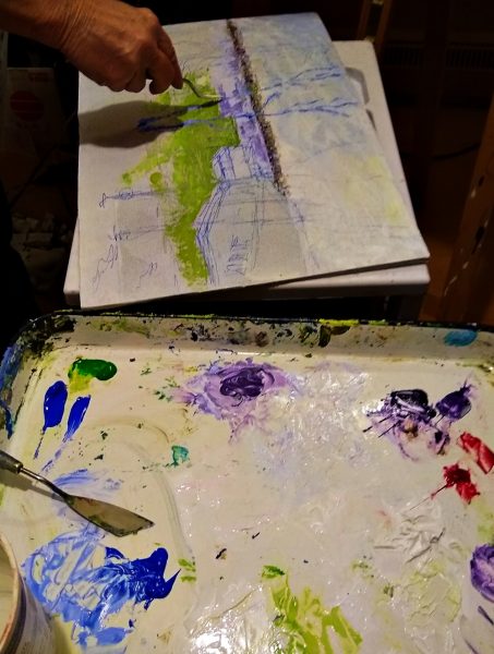Painting with a Palette Knife on a table with paints